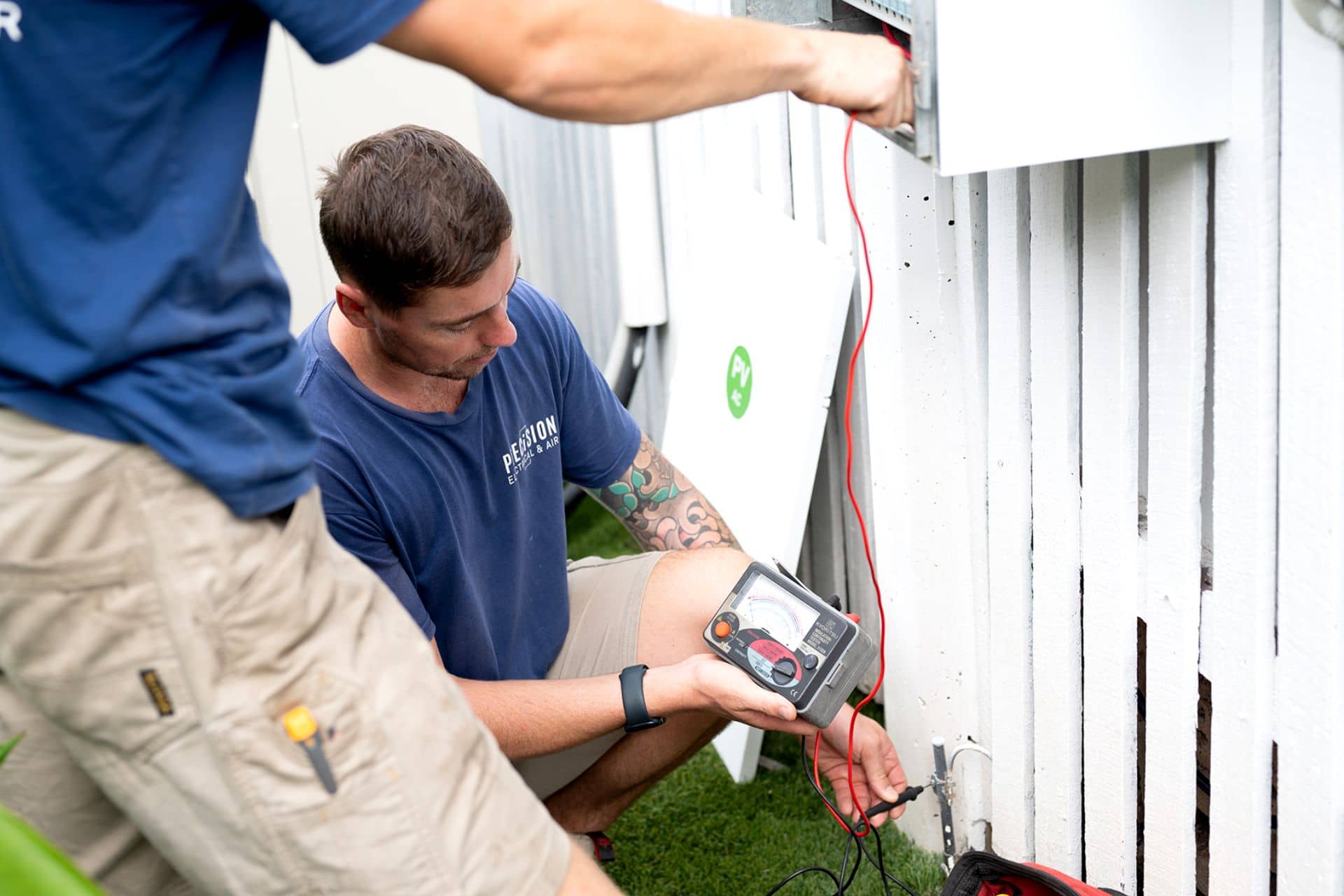 Precision Electrical & Air electricians testing a home switchboard in Brisbane