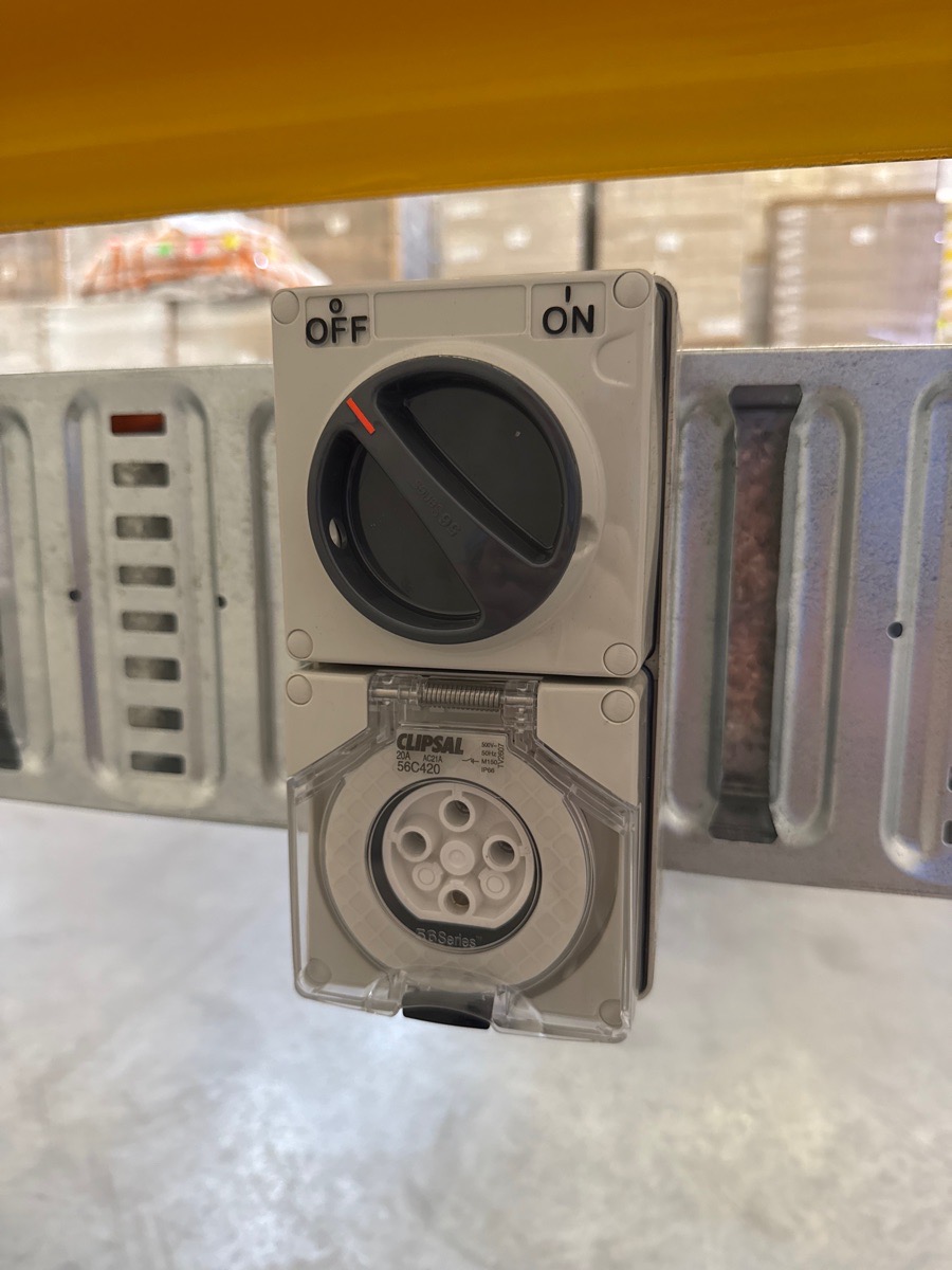 Three phase switched socket outlet installed on a wall